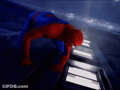 A Man In A Spiderman Costume Is Crawling On The Ground GIF