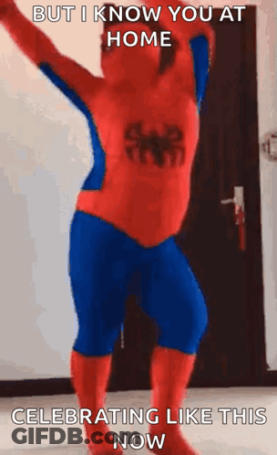 A Man In A Spiderman Costume Is Dancing In A Room . GIF