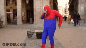 A Man In A Spiderman Costume Is Dancing On A Street GIF