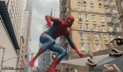 A Man In A Spiderman Costume Is Flying Through The Air In A City GIF