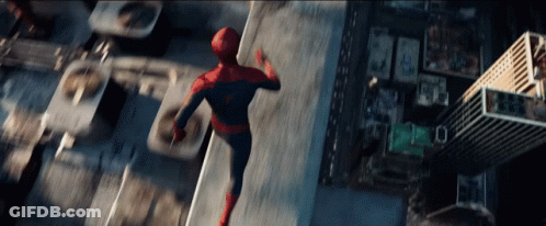 A Man In A Spiderman Costume Is Flying Through The Air Over A City GIF