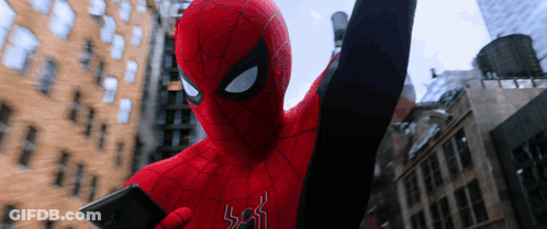 A Man In A Spiderman Costume Is Holding A Phone GIF