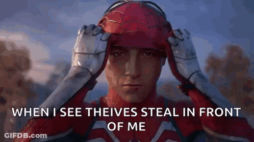 A Man In A Spiderman Costume Is Holding His Helmet Over His Head . GIF