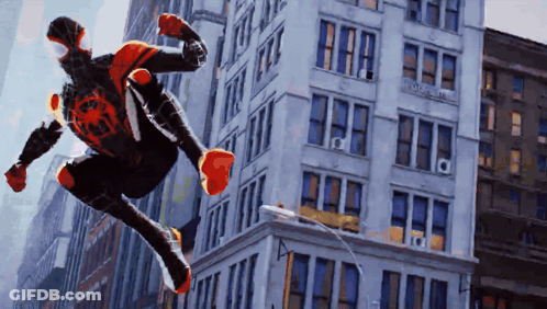 A Man In A Spiderman Costume Is Jumping Through The Air GIF