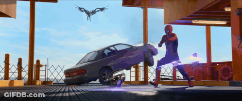 A Man In A Spiderman Costume Is Kicking A Car In A Parking Garage GIF