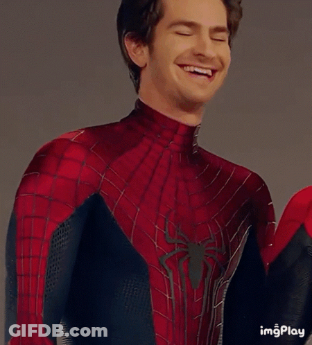 A Man In A Spiderman Costume Is Looking At The Camera GIF