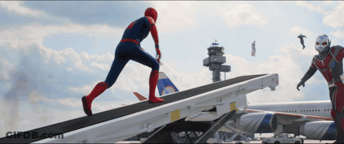 A Man In A Spiderman Costume Is Running Down A Ramp Next To An Ant Man GIF