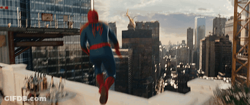 A Man In A Spiderman Costume Is Running On A Rooftop GIF
