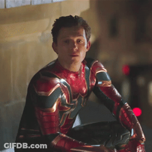 A Man In A Spiderman Costume Is Sitting On A Ledge Looking At Something . GIF