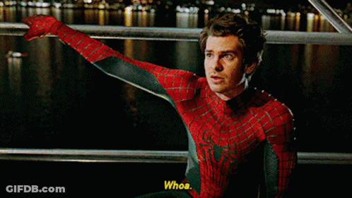 A Man In A Spiderman Costume Is Sitting On A Railing And Says Whoa GIF