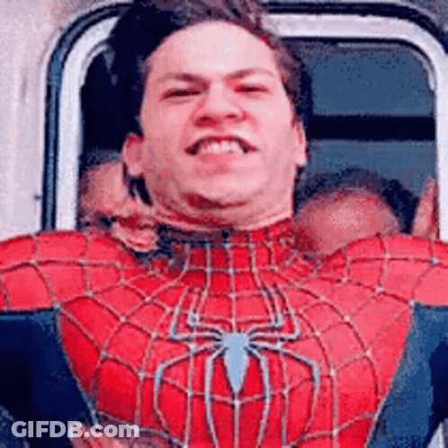 A Man In A Spiderman Costume Is Smiling While Sitting In A Car . GIF