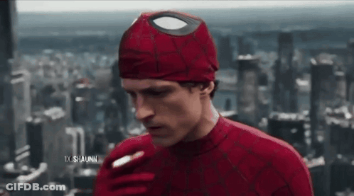A Man In A Spiderman Costume Is Smoking A Cigarette In Front Of A City Skyline . GIF