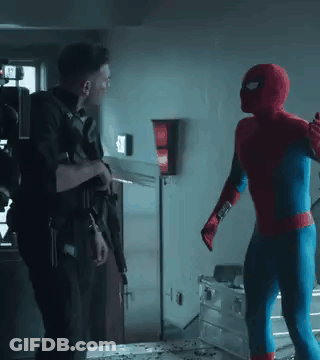 A Man In A Spiderman Costume Is Standing Next To A Man In A Military Uniform Holding A Gun . GIF