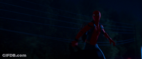 A Man In A Spiderman Costume Is Standing Next To A Power Line At Night GIF