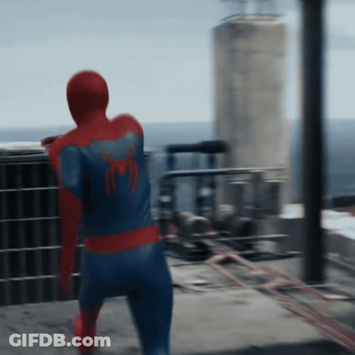 A Man In A Spiderman Costume Is Standing On A Balcony GIF