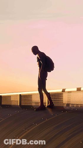 A Man In A Spiderman Costume Is Standing On A Roof GIF