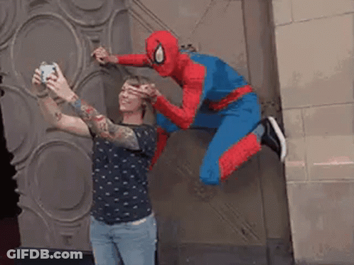 A Man In A Spiderman Costume Is Taking A Picture Of Himself GIF