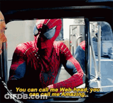 A Man In A Spiderman Costume Is Talking To Another Man . GIF