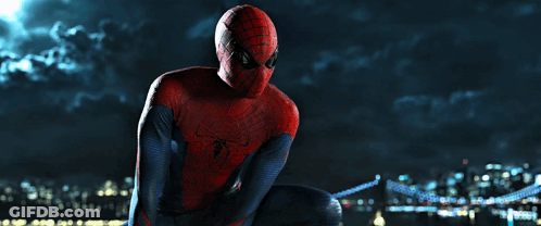 A Man In A Spiderman Costume Sits On A Bridge GIF