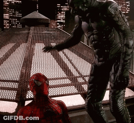 A Man In A Spiderman Costume Standing Next To Another Man In A Black Suit GIF