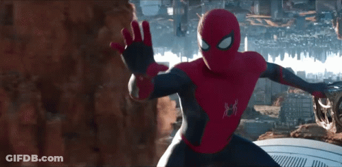 A Man In A Spiderman Costume Stands In Front Of A City Skyline GIF