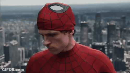 A Man In A Spiderman Costume Stands In Front Of A Cityscape GIF