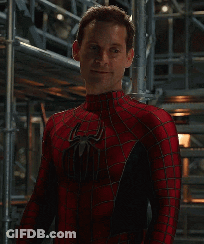A Man In A Spiderman Costume Stands In Front Of Scaffolding GIF