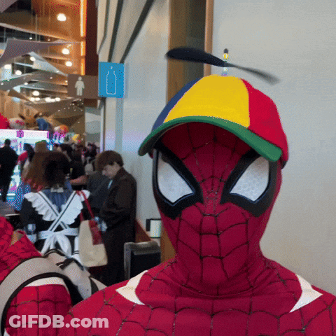 A Man In A Spiderman Costume With A Colorful Hat On GIF