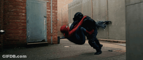 A Man In A Spiderman Suit Is Being Lifted In The Air By Another Man GIF