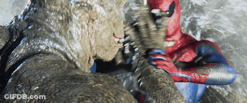 A Man In A Spiderman Suit Is Fighting A Giant Monster GIF
