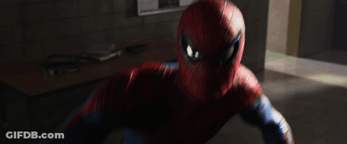 A Man In A Spiderman Suit Is Fighting A Monster In A Hallway GIF