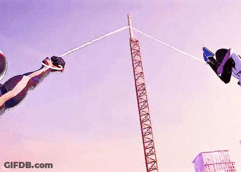 A Man In A Spiderman Suit Is Flying Through The Air GIF