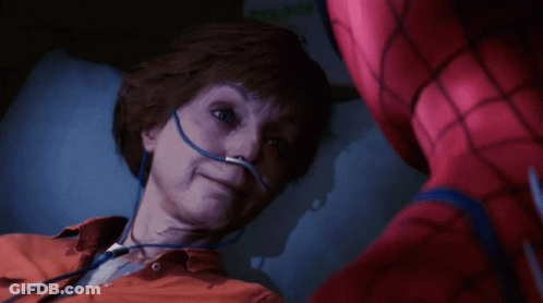 A Man In A Spiderman Suit Is Laying In A Hospital Bed GIF