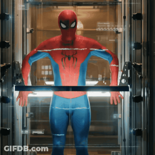 A Man In A Spiderman Suit Is Standing In A Glass Elevator GIF