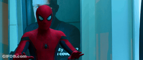A Man In A Spiderman Suit Is Standing In Front Of A Mirror That Says " I Cove " GIF