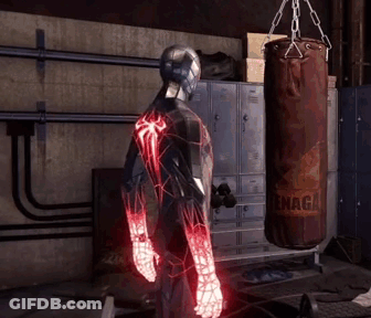 A Man In A Spiderman Suit Is Standing In Front Of A Punching Bag That Says ' Snaga ' On It GIF
