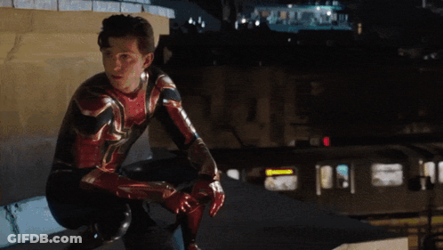 A Man In A Spiderman Suit Squatting Down GIF