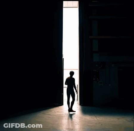 A Man In A Spiderman Suit Stands In Front Of A Door GIF