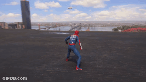 A Man In A Spiderman Suit Stands On A Rooftop With A Helicopter Flying In The Background GIF