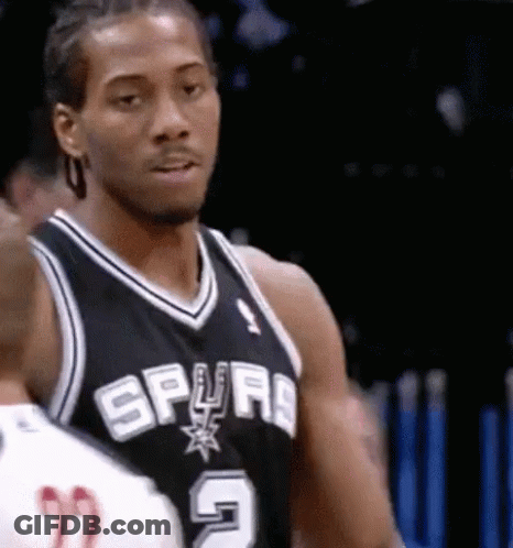 A Man In A Spurs Jersey Is Looking At Something GIF