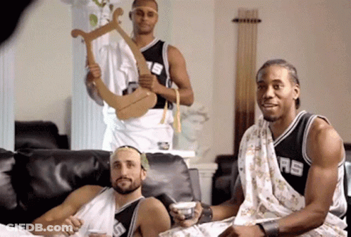 A Man In A Spurs Jersey Sits Next To Two Other Men GIF