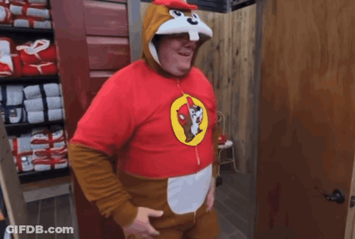A Man In A Squirrel Costume Is Standing In A Room GIF