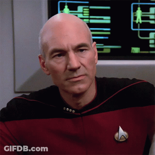 A Man In A Star Trek Uniform Has A Badge On His Chest GIF