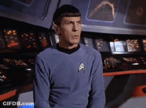 A Man In A Star Trek Uniform Is Sitting In Front Of A Console GIF