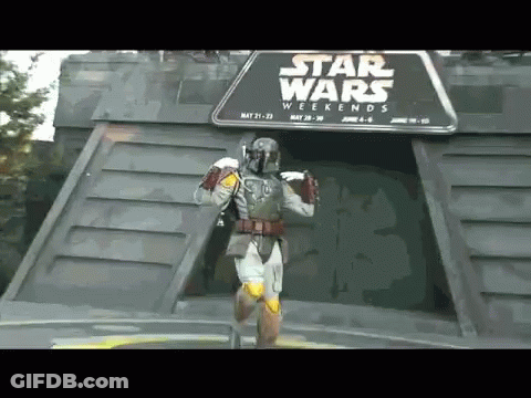A Man In A Star Wars Costume Is Standing In Front Of A Star Wars Weekends Sign GIF