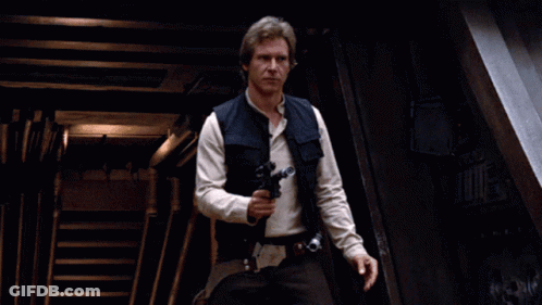 A Man In A Star Wars Outfit Holds A Gun In His Right Hand GIF