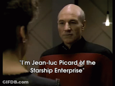 A Man In A Starship Enterprise Uniform Talks To Another Man GIF