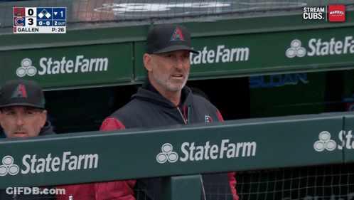 A Man In A State Farm Hat Sits In The Dugout During A Baseball Game GIF