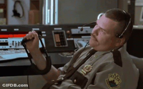 A Man In A State Trooper Uniform Is Talking On A Walkie Talkie GIF