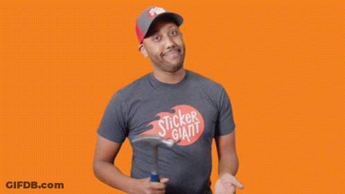 A Man In A Sticker Giant T-Shirt Holds A Hammer GIF